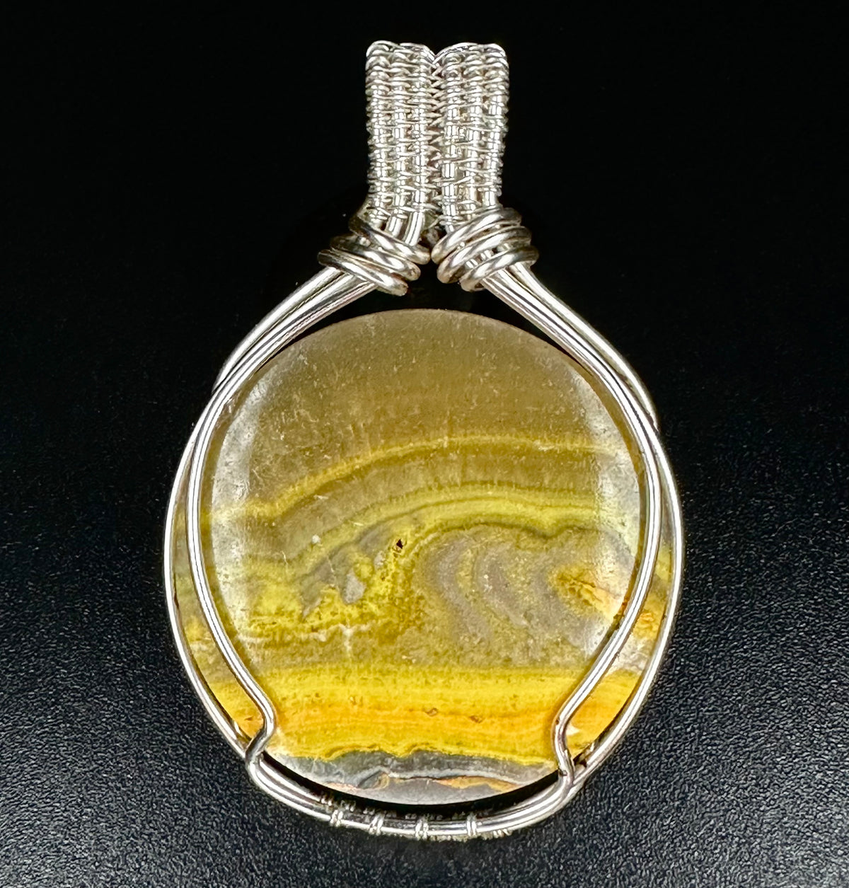 Natural Bumblebee Jasper pendant with golden yellow and grey banded patterns in a handcrafted silver wire setting.